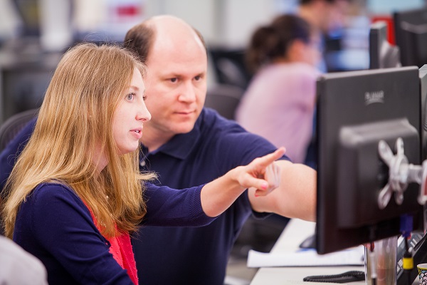 A Railinc customer support representative shows a new colleague how to log a case.